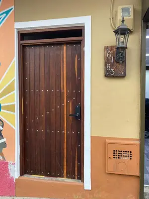 a wooden door on the side of a house at Casa Oasis - La Estrella in La Estrella