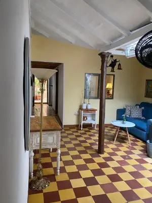 a living room with a blue couch and a checkered floor at Casa Oasis - La Estrella in La Estrella