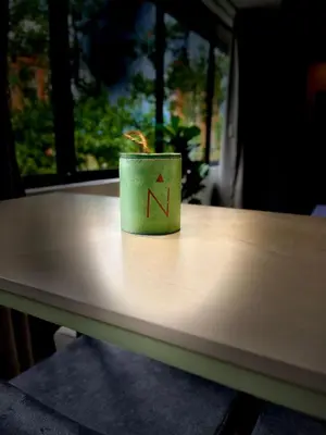 a green cup sitting on top of a table at Nice Apartment 205 in san lucas in Medellín