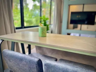 a table with two chairs with a candle on it at Nice Apartment 205 in san lucas in Medellín