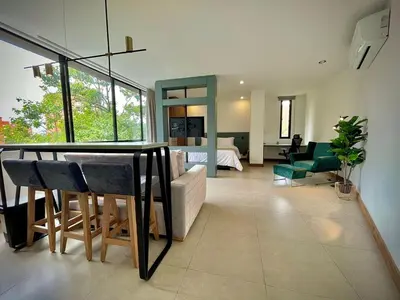 a living room with a couch and a dining room at Nice Apartment 205 in san lucas in Medellín