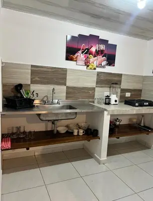 a kitchen with a sink and a counter top at Villa Guarne Merlot in Guarne