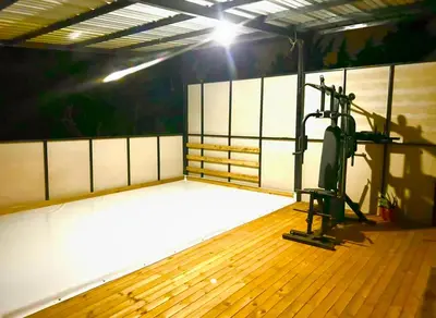 an empty gym with a treadmill in the middle at Villa Guarne Merlot in Guarne
