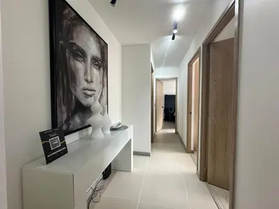 a hallway with a painting of a woman on a wall at apartamento familiar de 3 habitaciones por meses in La Estrella