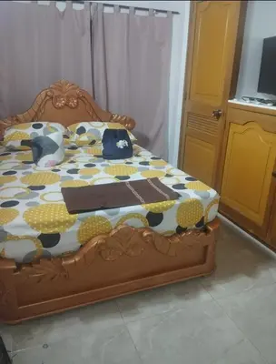 a bedroom with a bed with a quilt on it at Tu Lugar ideal in Envigado