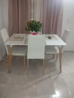 a white table and chairs with a potted plant on it at Tu Lugar ideal in Envigado