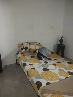 a bed with a polka dot blanket on it at Tu Lugar ideal in Envigado