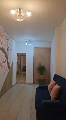 a living room with a blue couch and a wall at KaVal in Jardin