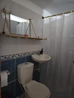a bathroom with a toilet and a sink at KaVal in Jardin