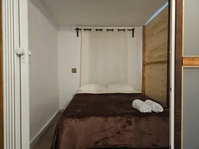 a small bedroom with a bed with two white pillows at KaVal in Jardin