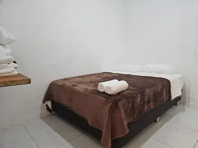 a bed with two rolled towels on top of it at KaVal in Jardin