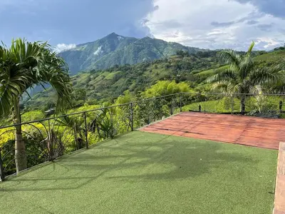 a balcony with a view of a mountain at Casa colonial hermosa divisa a 1 45 h de Medellin in Venecia