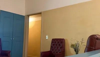 a room with two leather chairs and a mirror at Autenthico Provenza Home Medellin in Medellín