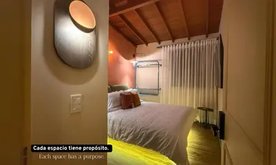 a bedroom with a bed and a mirror on the wall at Autenthico Provenza Home Medellin in Medellín