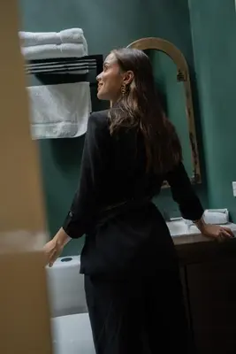 a woman standing in front of a bathroom mirror at Autenthico Provenza Home Medellin in Medellín