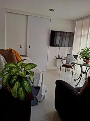 a living room with a bed and a couch and a table at Casa Tobi in Rionegro