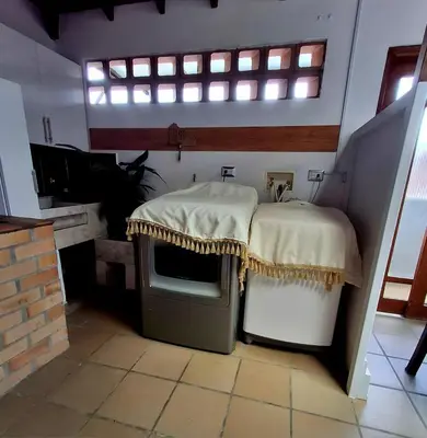 a room with two tables and a tv and a window at Casa Tobi in Rionegro