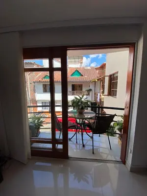 a room with a door open to a patio with a table at Casa Tobi in Rionegro