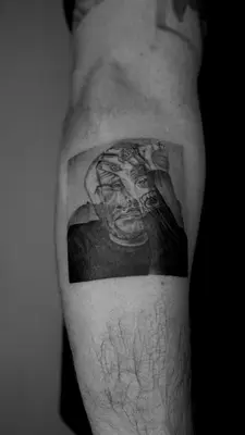 a man with a tattoo on his arm at Kintin Tattoo Hostel in Jardin