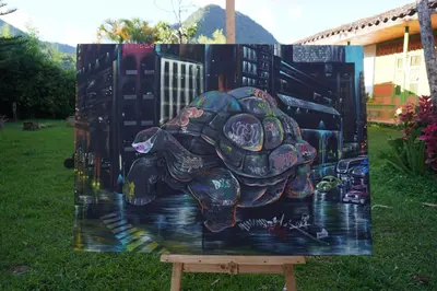 a painting of a turtle on a table in the grass at Kintin Tattoo Hostel in Jardin