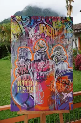a sign covered in graffiti on a fence at Kintin Tattoo Hostel in Jardin