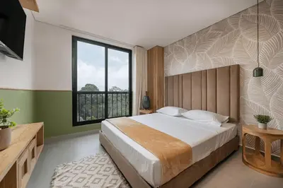 a bedroom with a large bed and a large window at Poblado Apt with King bed and Free parking 216 in Medellín