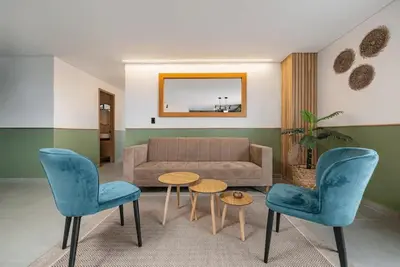 a living room with a couch and chairs and a table at Poblado Apt with King bed and Free parking 216 in Medellín