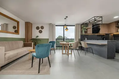 a living room with a couch and a table and chairs at Poblado Apt with King bed and Free parking 216 in Medellín