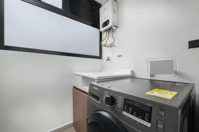 a kitchen with a washing machine in a room at Poblado Apt with King bed and Free parking 216 in Medellín