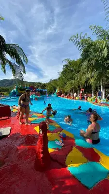 a group of people in a pool at a resort at consorcio club Paradise in San Rafael