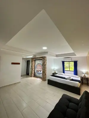 a large bedroom with a bed and a couch at consorcio club Paradise in San Rafael