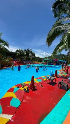 a large swimming pool with people in the water at consorcio club Paradise in San Rafael