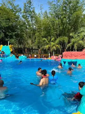 a group of people in the water at a swimming pool at consorcio club Paradise in San Rafael