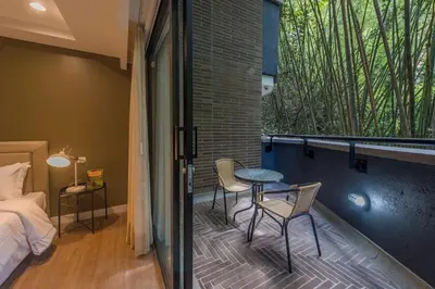 a bedroom with a balcony with a table and chairs at DUP 315 Tesoro - Cls in Medellín