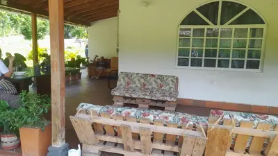 a couch sitting on the porch of a house at Casa de Pacho in Bello