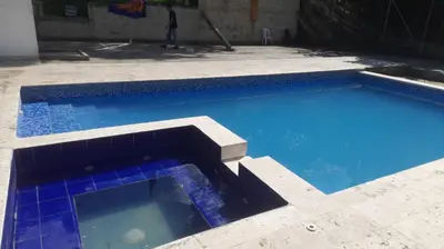a large swimming pool with blue water in a yard at Casa de Pacho in Bello