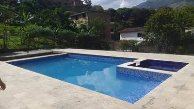 a swimming pool with blue water in a backyard at Casa de Pacho in Bello