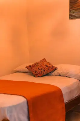 a bed with a pillow sitting on top of it at Índigo Cowork in San Rafael