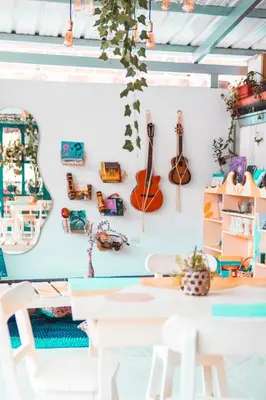 a room with a table and chairs and a guitar on a wall at Índigo Cowork in San Rafael