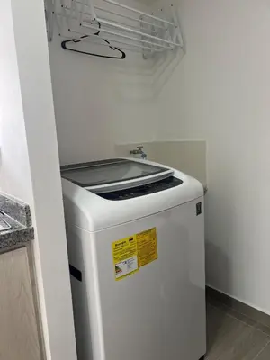 a white refrigerator in a room with a wall at Apartamento TERMINAL DE TRANSPORTE, CABLE AEREO, DOLLARCITY, D1 in Manizales