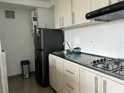 a kitchen with a black refrigerator and a sink at Apartamento TERMINAL DE TRANSPORTE, CABLE AEREO, DOLLARCITY, D1 in Manizales