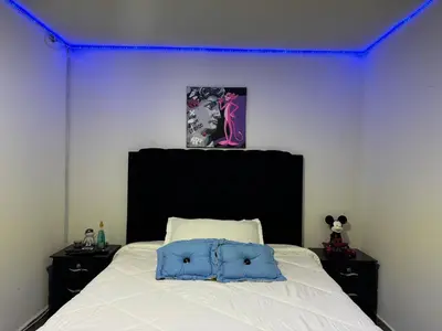 a bedroom with a white bed with a purple ceiling at Apartamento alto de palmas 1 in Medellín