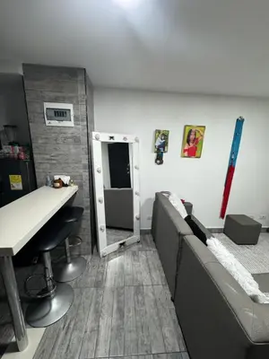 a room with a bed and a table and a mirror at Apartamento alto de palmas 1 in Medellín