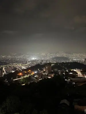 a view of a city at night at Apartamento alto de palmas 1 in Medellín