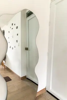 a hallway with an open door with a mirror at Apartamento via TERMALES Y LOS NEVADOS in Manizales