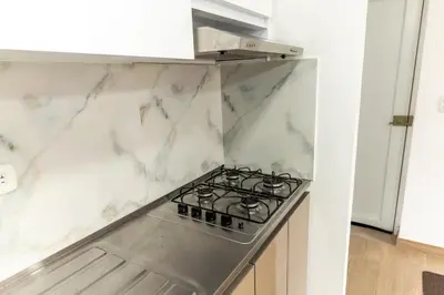 a kitchen with a stove top oven in a kitchen at Apartamento via TERMALES Y LOS NEVADOS in Manizales