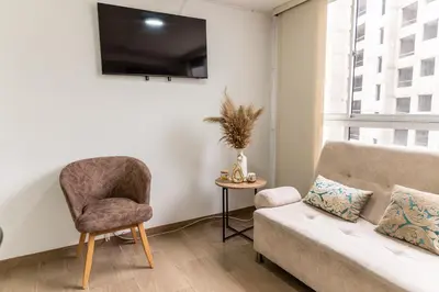a living room with a couch and a chair at Apartamento via TERMALES Y LOS NEVADOS in Manizales