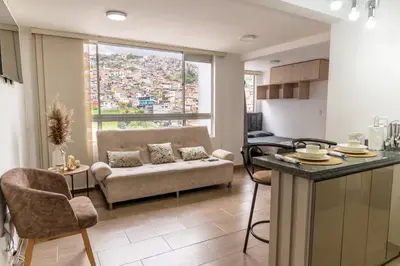 a living room with a couch and a table at Apartamento via TERMALES Y LOS NEVADOS in Manizales