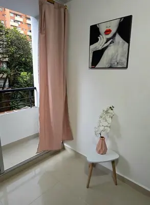 a room with a window and a vase of flowers on a table at Cálido y moderno lugar Sabaneta in Sabaneta