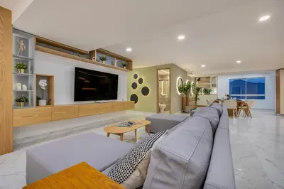 a living room with a large couch and a tv at Opulent and Luxury 4 Bedroom in Sabaneta
